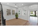 Bright living room with carpet and wood flooring, large windows and a ceiling fan at 3830 E Appaloosa Rd, Gilbert, AZ 85296