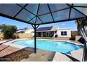 Backyard pool area with a covered patio and solar panels on the roof at 4631 W Mcrae Way, Glendale, AZ 85308