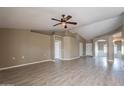 Spacious living room featuring neutral paint, vaulted ceilings, and modern laminate flooring at 4873 E Magnus Dr, San Tan Valley, AZ 85140