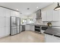 Bright kitchen with stainless steel appliances, white cabinets, and marble backsplash at 5202 E Marconi Ave, Scottsdale, AZ 85254