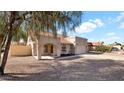 Beautiful single-story home featuring an arched entry way, desert landscaping and a two-car garage at 7109 W Julie Dr, Glendale, AZ 85308