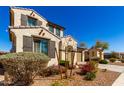 View of a two-story home showcasing a stucco exterior, tile roof, shutters and landscaped yard at 9144 W Surrey Dr, Peoria, AZ 85381