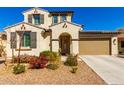 Charming two-story home featuring a stucco exterior, tile roof, shutters and a well-manicured front yard at 9144 W Surrey Dr, Peoria, AZ 85381