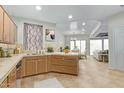 Bright kitchen features light wood cabinets, and an open floor plan extending to the living room and dining area at 9716 N 3Rd Dr, Phoenix, AZ 85021