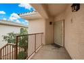 Cozy outdoor porch area with a secure door and railing that enhances the property's appeal at 10030 W Indian School Rd # 203, Phoenix, AZ 85037