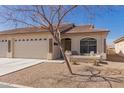 Inviting single-story home with a two-car garage, covered porch and desert landscaping at 10960 E Monte Ave # 131, Mesa, AZ 85209