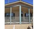 Charming home featuring a covered front porch with railing and a light-colored exterior at 11411 N 91St Ave # 175, Peoria, AZ 85345