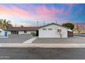 Beautifully landscaped front yard featuring a stylish concrete walkway, decorative stone, and fresh exterior paint at 1744 E Luke Ave, Phoenix, AZ 85016