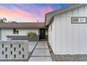 Inviting home exterior with a contemporary walkway leading to the front entrance, complemented by subtle landscape lighting at 1744 E Luke Ave, Phoenix, AZ 85016