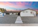 Charming single-story home with a modern walkway, low-maintenance landscaping, and a welcoming facade at 1744 E Luke Ave, Phoenix, AZ 85016