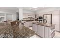 Open concept kitchen with granite counters, stainless steel appliances, and ample cabinet space at 18140 N Saddle Ridge Dr, Surprise, AZ 85374