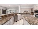 Spacious kitchen featuring granite countertops and an island with views into living areas at 18140 N Saddle Ridge Dr, Surprise, AZ 85374