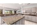 Bright kitchen showcasing granite countertops, tile backsplash, and modern appliances at 18140 N Saddle Ridge Dr, Surprise, AZ 85374
