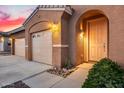 Charming home featuring a three car garage, front door and desert landscaping at 19140 W Pasadena Ave, Litchfield Park, AZ 85340