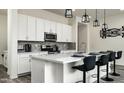 Modern kitchen features sleek countertops, stainless steel appliances, and a convenient breakfast bar at 1953 W Kinfield Trl, Phoenix, AZ 85085