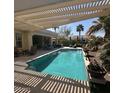 Inviting outdoor pool area with ample seating and a serene backyard at 2120 N 166Th Dr, Goodyear, AZ 85395