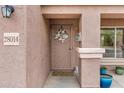 Close-up of front door with decorative wreath, number plaque and stucco exterior at 28014 N Jade St, San Tan Valley, AZ 85143