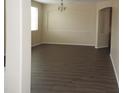 Open-concept living room featuring wood floors, natural lighting, and neutral walls at 29673 N 120Th Ln, Peoria, AZ 85383