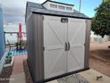 New storage shed with double doors provides secure outdoor storage space at 44 S Hawes Rd # B7, Mesa, AZ 85208