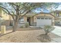 Charming single-story home with a two-car garage and well-maintained front yard at 4613 W Ellis St, Laveen, AZ 85339