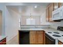 Efficient kitchen features wood cabinets, laminate countertops, and modern appliances at 4613 W Ellis St, Laveen, AZ 85339