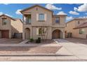 Charming two-story home featuring a private balcony, arched entry, and an attached garage at 5427 W Odeum Ln, Phoenix, AZ 85043