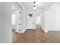 Bright foyer with tile flooring, arched doorways, and white trim at 5446 S Sandstone Ct, Gilbert, AZ 85298
