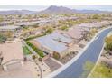 Expansive aerial view of the home, highlighting its proximity to the neighborhood, mountains, and street at 6130 E Bramble Berry Ln, Cave Creek, AZ 85331