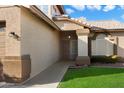 Inviting covered front porch with tiled roof and desert landscaping at 7648 W Betty Elyse Ln, Peoria, AZ 85382