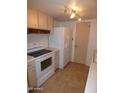 Well-lit kitchen featuring appliances, white cabinets and tile floors at 7917 E Keim Dr, Scottsdale, AZ 85250