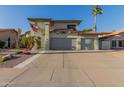 Well-maintained two-story home with a spacious three-car garage and mature landscaping under clear skies at 826 W Royal Palms Dr, Gilbert, AZ 85233
