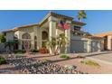 Beautiful two-story home with a three-car garage, landscaped front yard, and mature landscaping under a blue sky at 826 W Royal Palms Dr, Gilbert, AZ 85233