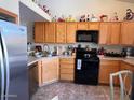The kitchen is equipped with stainless steel appliances and wooden cabinets at 8900 E Rainier Dr, Gold Canyon, AZ 85118