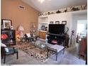 A cozy living room is decorated with vases, furniture, and a fireplace at 8900 E Rainier Dr, Gold Canyon, AZ 85118