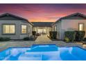 Inviting backyard featuring a sparkling pool and beautiful patio pavers at 9960 E Revolution Dr, Mesa, AZ 85212