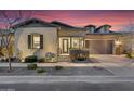 Charming single-story home featuring desert landscaping and a two-car garage at 9960 E Revolution Dr, Mesa, AZ 85212