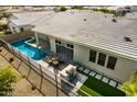 Aerial view of pool and patio with outdoor seating and a built-in barbeque grill at 11203 N Northfield St, Surprise, AZ 85388