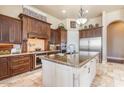Gourmet kitchen showcasing custom wood cabinets, granite countertops, stainless steel appliances, and tiled flooring at 11225 E Starflower Ct, Chandler, AZ 85249