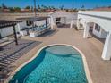 Outdoor living featuring a pool, BBQ, bar, and covered seating area; perfect for entertaining guests at 11225 E Starflower Ct, Chandler, AZ 85249