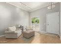 Bright living room with wood floors, neutral walls, and comfortable seating area at 13226 N Cedar Dr, Sun City, AZ 85351