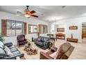 Bright living room with wood floors, plantation shutters, and ample seating at 14302 W Laurel Ln, Surprise, AZ 85379