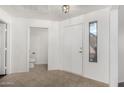 Bright entryway with tile flooring, featuring a front door and a glimpse of the powder room at 15225 N 100Th St # 2210, Scottsdale, AZ 85260