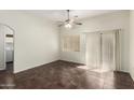 Bright living room with tile floors, ceiling fan, and sliding door to patio at 17150 N 23Rd St # 249, Phoenix, AZ 85022