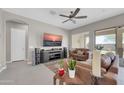 Comfortable living area featuring neutral tile flooring, a ceiling fan, and ample space for furniture at 18837 N Cook Dr, Maricopa, AZ 85138