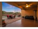 Cozy covered patio with a ceiling fan, comfortable seating, and a beautiful outdoor dining area perfect for entertaining at 2330 E Lieber Pl, Phoenix, AZ 85024