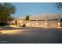 Well-maintained exterior showing a spacious driveway and multiple car garage with exterior lighting at 27171 N 73Rd St, Scottsdale, AZ 85266