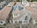 Aerial view of home with solar panels on roof in a neighborhood with tile roofs and manicured landscaping at 3438 E Betsy Ln, Gilbert, AZ 85296