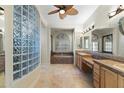 A spacious bathroom features a tiled shower, soaking tub, dual sinks, and ample natural light creating a spa-like retreat at 41601 N River Bend Rd, Anthem, AZ 85086