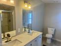 Bright bathroom features a double sink vanity with marbled countertop, modern fixtures, and toilet at 420 S 98Th Way, Mesa, AZ 85208