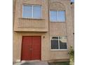 Close-up of a two-story home with a stucco facade and a red double-door entry at 4258 N 68Th Ln, Phoenix, AZ 85033